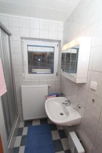 法克湖畔杜罗博拉赫Ferienwohnungen Petschnig 3的白色的浴室设有水槽和窗户。