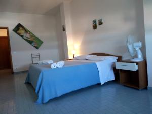 托里德欧索Casa Fiore的一间卧室配有蓝色的床和毛巾