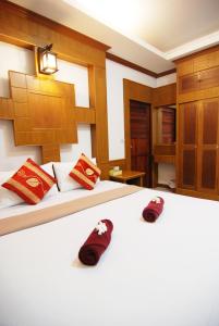 高兰兰塔自然海滩度假村的一间卧室配有两张床和红色拖鞋。