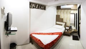 纳威孟买Hotel Fantacee的小房间设有床和电视