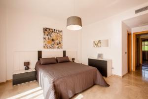 圣地亚哥港Residencial Playa de La Arena的一间白色客房内的床铺卧室