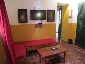 格雷岛Chez Eric的客厅配有红色沙发和电视