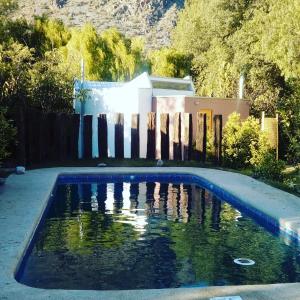 维库尼亚Organica Lodge Spa的围栏旁的院子内的游泳池