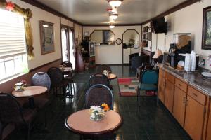 尤里卡斯普林斯Regency Inn Eureka Springs的一间在房间内配有桌椅的餐厅