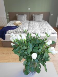 维也纳奥特丹旅馆的卧室配有一张带白色花瓶的床