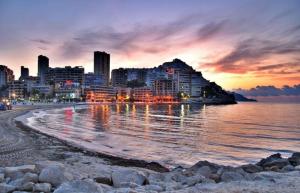 卡拉德费斯特拉特奥卡尼亚公寓酒店的日落时分可欣赏海滩和城市美景