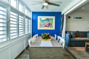 East EndVilla Nautilus St. Thomas的一间拥有蓝色墙壁和桌椅的用餐室