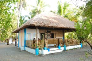 Sablayan萨布拉延帕拉伊索海滩度假酒店的一个小小屋,里面的人站在里面