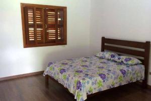 圣安东尼奥-杜皮尼亚尔Recanto da Maya的一间卧室设有一张床和一个窗口