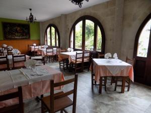 诺瓦莱斯Posada La Ceña的用餐室设有桌椅和窗户。