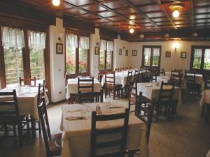 贝拉吉奥阿尔贝格拉格尼兹安内拉酒店的用餐室设有桌椅和窗户。