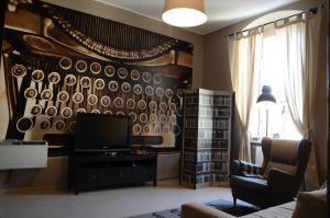马泰拉圣尤斯塔其欧公寓的客厅配有电视和带盘子的墙壁