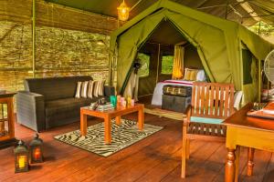 贝里胡罗亚Ahaspokuna by Eco Team的客厅设有1个带沙发和桌子的帐篷