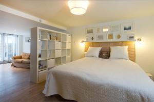 赞德沃特萨奥提勒公寓的卧室配有一张白色的大床和一张沙发。