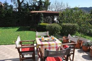 伊利索斯Beautiful house with garden in Rhodes的一张桌子、四把椅子和一个凉亭