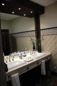 Corral de AlmaguerCasa Rural Mendoza的一间带两个盥洗盆和大镜子的浴室