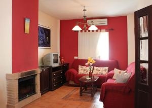 埃尔博斯克Casa Gil - La Vega的客厅设有红色的墙壁和壁炉