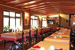 普雷圣迪迪埃土拨鼠旅馆的用餐室设有桌椅和窗户。
