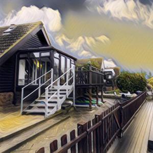 IslehamIsleham River Lodge的一本房子的画,上面有火车