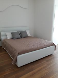 滨海波利尼亚诺Il sogno di Ele的卧室内的一张床位,卧室设有白色的墙壁