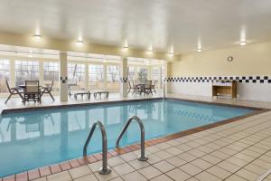 奥马哈卡尔森江山旅馆 - 奥马哈机场的一座配有桌椅的酒店游泳池