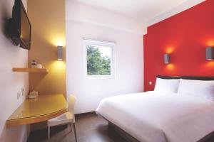万隆亚玛瑞斯赛汉姆佩勒斯酒店的一间酒店客房,配有一张白色的床和一张书桌