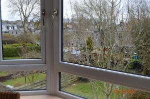 邓弗姆林Holiday Apartment Dunfermline的两个窗户,位于一个房间,可眺望庭院