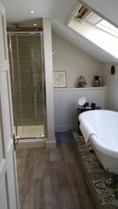圣艾夫斯Headland House Luxury B&B的一间带大浴缸和淋浴的浴室