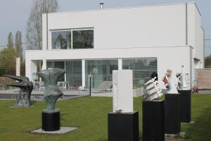 BerlaarB&B Het Museum的建筑前方展示雕塑的建筑