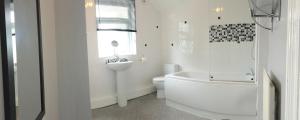 诺斯维奇Royle House by SG Property Group的带浴缸、卫生间和盥洗盆的浴室