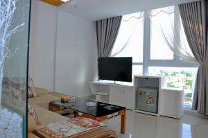 广义坎坦酒店的白色的客厅配有电视和沙发