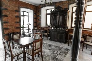 鄂木斯克砖墙宾馆的用餐室设有桌椅和砖墙
