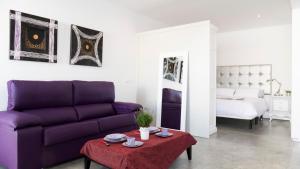 科尔多瓦图里斯提科卡里法尔公寓的客厅配有紫色沙发和床。