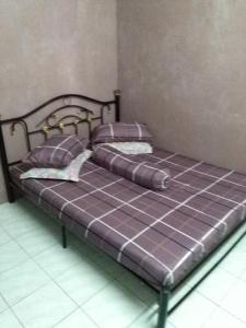 阿罗士打狄纳乌塔拉民宿的一张位于房间的床,上面有两个枕头