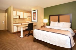 森特尼尔Extended Stay America Select Suites - Denver - Tech Center South的配有一张床和一张书桌的酒店客房