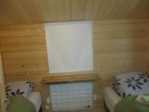 ÞórshöfnSmyrill Cottages的一间设有两张床的房间和一个位于小屋的窗户