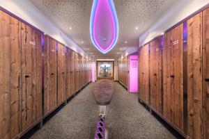 扎奥岑湖奥鹏霍夫高级酒店的更衣室设有木墙和紫色灯