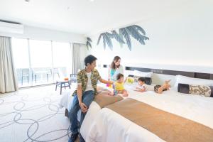 名户金秀喜瀬海滩宫殿酒店的一群人坐在床上