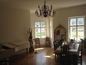 萨尔茨堡Sarah's Altstadt Oase Salzburg的客厅配有钢琴、桌子和镜子