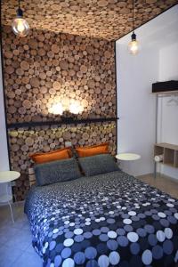 卢切拉la casa di asmei b & b Lucera的一间卧室设有一张床和一堵木墙