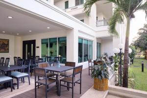 万象萨默塞特万象酒店式公寓的一个带桌椅的庭院和棕榈树