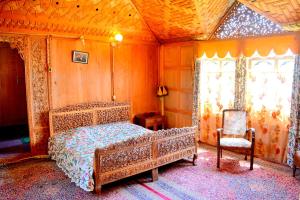 斯利那加Kings Houseboats的一间卧室配有一张床和一把椅子