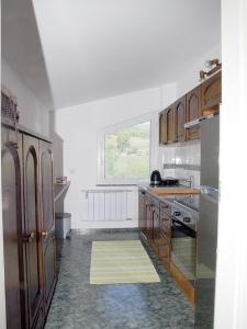 马里博尔Apartment Zupan的厨房设有白色的墙壁、木制橱柜和窗户。