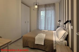 佩鲁贾Casa Rimidia FLAT GIOVANNA的一间卧室配有一张床,上面有两条毛巾
