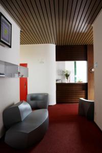 基亚索Hotel Garni Centro的一间设有两把椅子和一张桌子的等候室