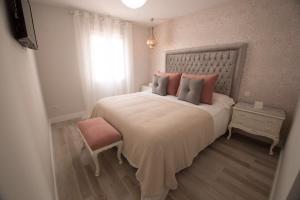 科尔多瓦Apartamento El Balcon de la Muralla的一间卧室设有一张大床和一个窗户。