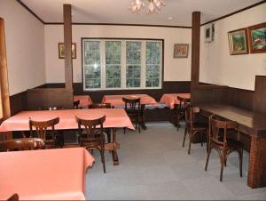 松本诗意酒店的一间带桌椅的用餐室和窗户。