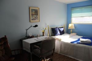 温尼伯温尼伯民宿的一间卧室配有一张床和一张桌子及椅子