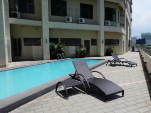 宿务曼德闰普拉扎酒店的一座游泳池旁设有两把躺椅