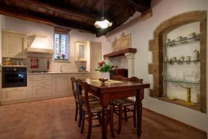 皮蒂利亚诺Casetta Nella Fratta的厨房配有木桌和椅子